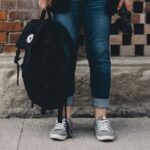 Teen Holding Backpack