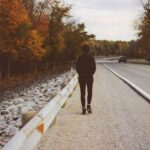 Teen walking on road